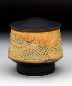 tea jar with fish motif and matte black glaze